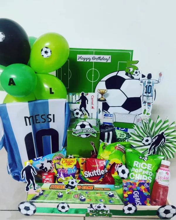 For the die-hard football fan, this Messi-themed hamper is the ultimate goal. It includes an Argentina jersey, a soccer-themed backdrop, and a curated selection of green and white snacks and goodies.