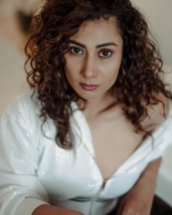This high-angle shot creates a direct and intimate connection with the viewer. The focus is entirely on the model's expressive eyes and features.