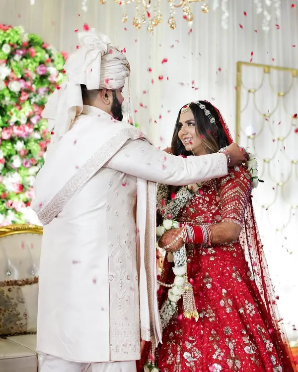 Hero Item. The Jaimala ceremony is a moment of pure joy and union. We captured this beautiful exchange between Akanksha and Dishant as flower petals rained down, freezing this perfect, unscripted celebration of their love story.