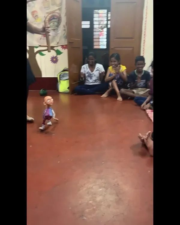A child from Makkala Jagriti is captivated as our 'Popo' thatha puppet seems to walk all by itself. The laughter and high energy in these community shows are absolutely contagious.