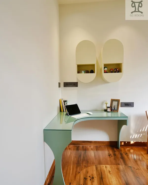 This custom-designed study desk features a curved glass top, making the workspace feel open and light. It's a functional and stylish solution that doesn't feel bulky in the corner of the room.