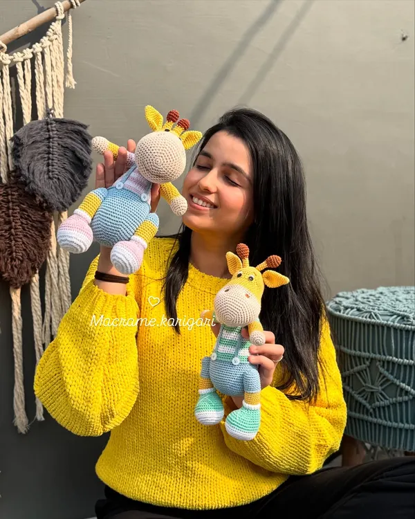 Here I am with our beloved giraffe duo, Tinu and Minu. These were some of the first amigurumi toys we designed, and they hold a special place in our hearts. Their lanky legs and sweet faces make them a favorite among kids.
