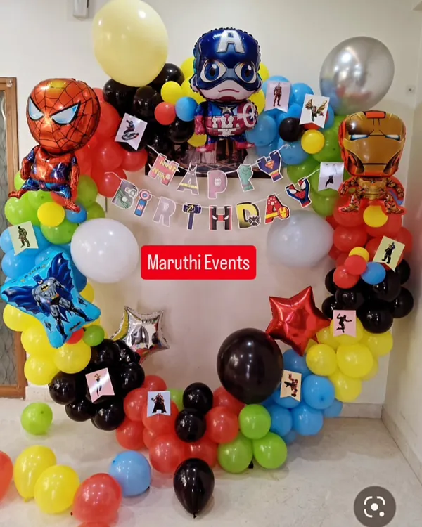 A full superhero team-up for a birthday bash. This circular balloon arch is decorated with foil balloons of Spiderman, Captain America, and Iron Man, creating an exciting centerpiece for the party.