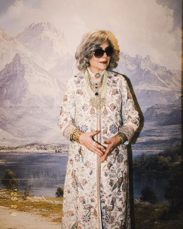 The legendary Zeenat Aman styled for 'The Royals' on Netflix. This look features a full length printed jacket by Anita Dongre, paired with layers of magnificent Polki and pearl necklaces for a truly regal effect.