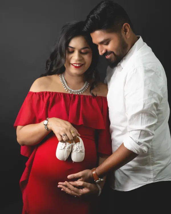 Those tiny shoes represent a huge, wonderful dream coming true. We love capturing this classic maternity pose with couples, focusing on the hands that will soon hold their little one.