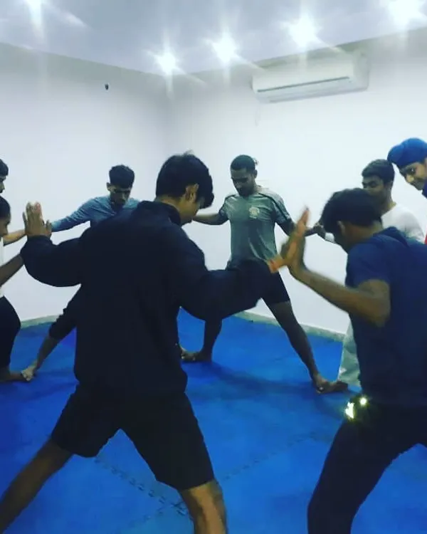 Flexibility is crucial for executing advanced techniques and preventing injuries. Here, our team engages in a group stretching exercise to improve mobility.