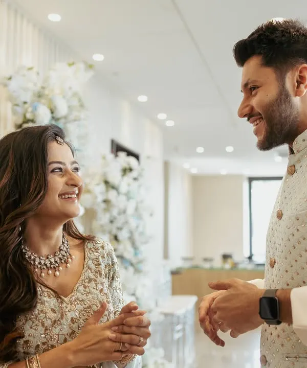 The moment it begins. We love capturing the raw, candid reactions during an engagement, like this shared laugh between Aditi and Rushang.