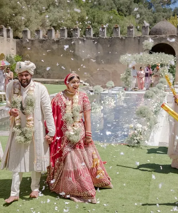 Bhakti and Pratham after their sunset pheras, showered with confetti. This joyful moment captures the celebration and happiness of being newly married.