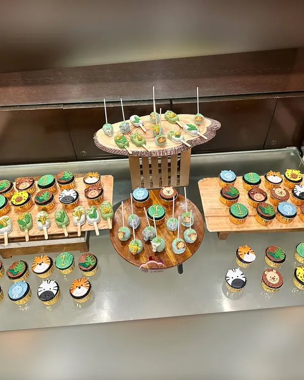 This is what I mean by a dessert table that tells a story. For this 'Wild One' first birthday, I created a full jungle experience with a variety of themed treats, including custom cupcakes, cakesicles, and cake pops, all beautifully arranged to wow the guests.