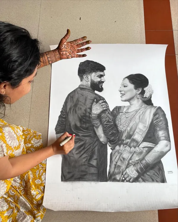 Here you can see me working on a large-scale pencil portrait, a skill that I bring to every mehendi design. My ability to draw faces and figures on paper ensures I can create detailed and accurate portraits for you in henna.