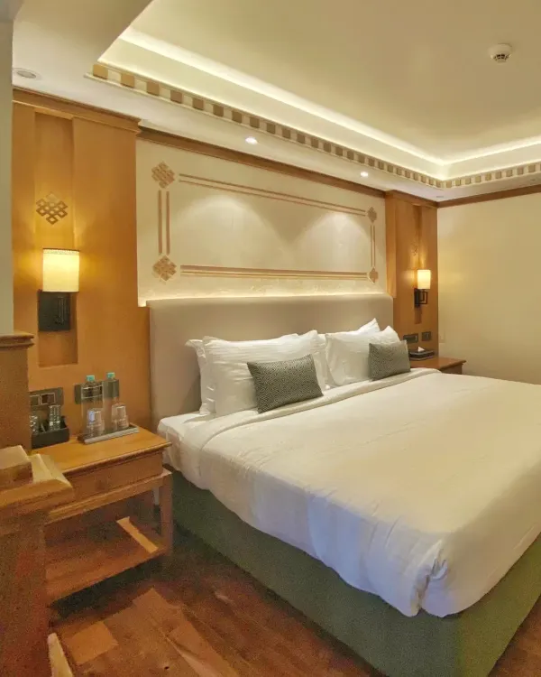 A look at the master bed in our Gangtok project for ITC hotels. We used soft, indirect lighting in the ceiling cove and custom wall paneling with traditional motifs to create a restful and luxurious ambiance.