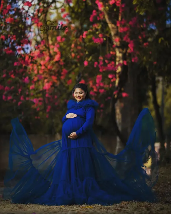 This flowing teal blue maternity gown is one of my most requested pieces. It features a detachable net skirt and a comfortable fish-cut inner dress, making it perfect for creating dramatic, flowing shots during your maternity photoshoot.