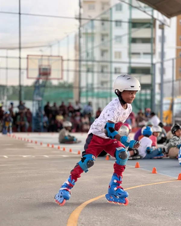 A young skater shows great form and concentration during our in-house skating competition on the multi-purpose court.