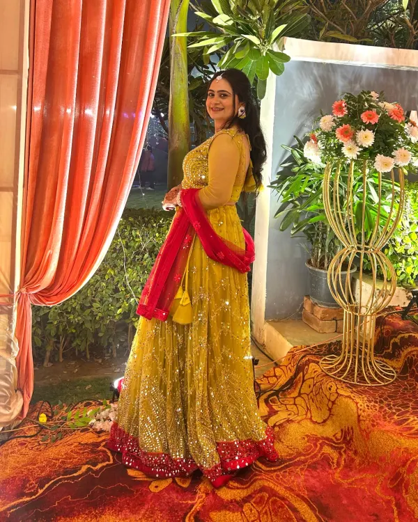 A perfect Haldi or Mehendi look. This client is wearing a bright yellow lehenga with a contrasting pink dupatta, paired with glowing makeup for her pre-wedding event.
