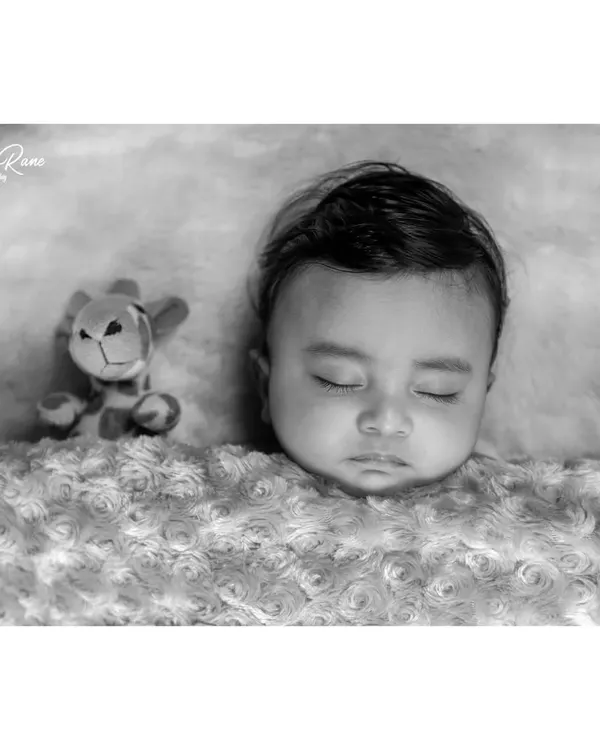 There is a timeless elegance to a black and white portrait. This style emphasizes the soft textures and peaceful expression of a sleeping baby, creating a beautiful piece of art that focuses purely on your little one.