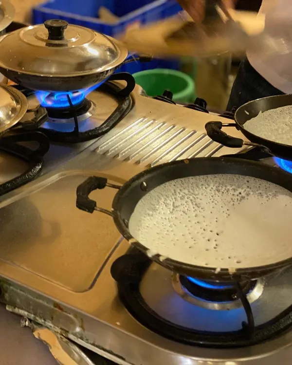 A glimpse of our live appam station in action. We bring the authentic taste of South Indian cuisine directly to your event, ensuring every serving is fresh, hot, and made right before your eyes.