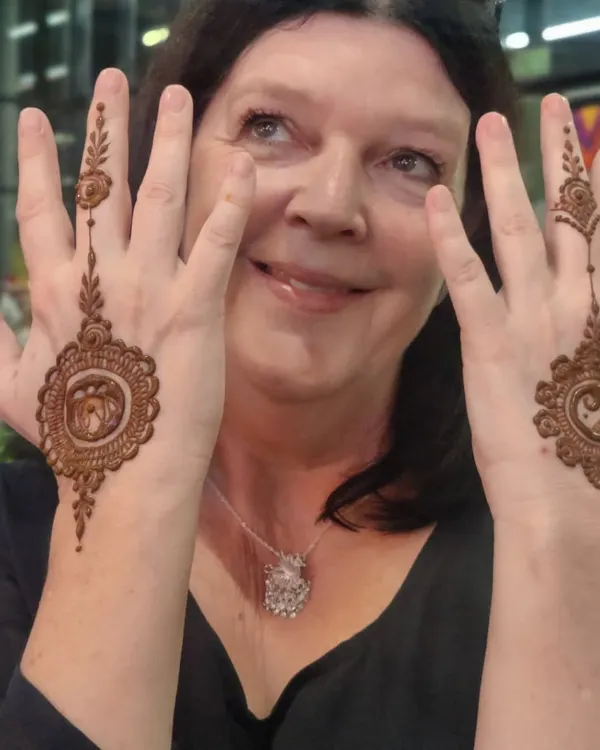 A happy client at a corporate event showing off her matching mandala designs. I love bringing the joy of mehendi to parties and seeing smiles like this.