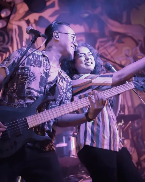 This is us, Dhruvi and Johaan, sharing a laugh on stage. Our connection is the foundation of the band's energy and chemistry.