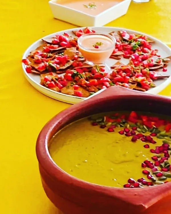 A healthy party platter featuring my homemade, plant-based baked nachos and a summer cold soup served with a vegan mayo dip. It's vibrant, delicious, and completely guilt-free.