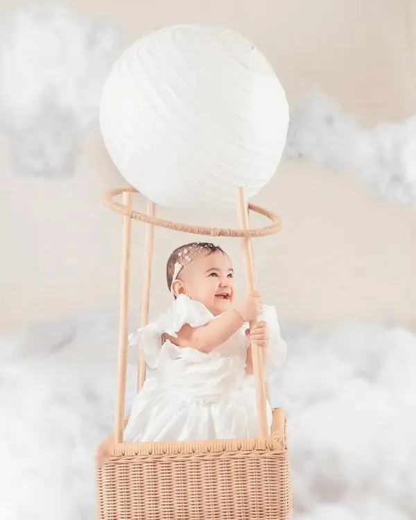 This little angel is floating on a cloud in our dreamy hot air balloon setup. I love creating these whimsical, imaginative scenes that turn a simple milestone photoshoot into a magical memory.