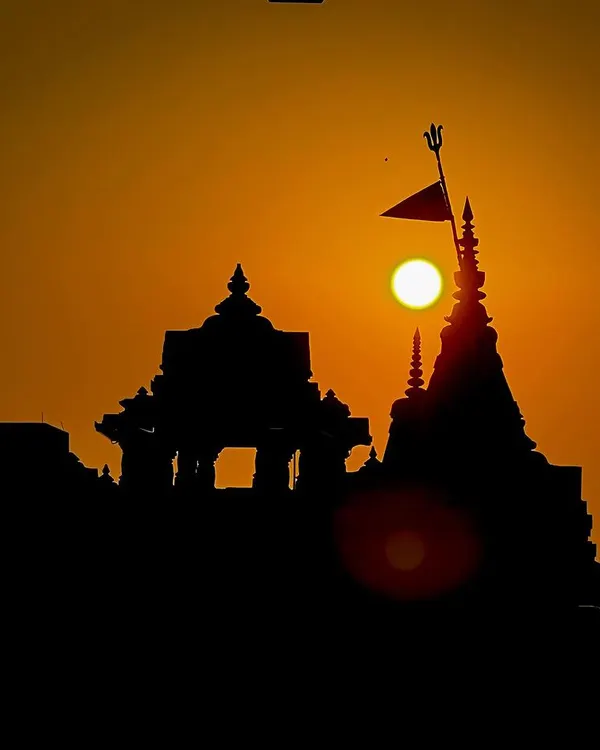A temple stands in silhouette against the morning sun. For me, this is a moment of quiet devotion, where faith and nature meet in a simple, powerful frame. This is a classic golden hour shot that speaks to India's spiritual heart.