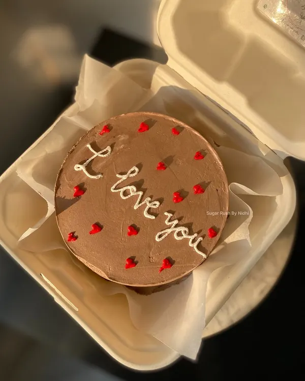 A simple and sweet chocolate truffle bento cake with an "I love you" message, perfect for an anniversary or just because.