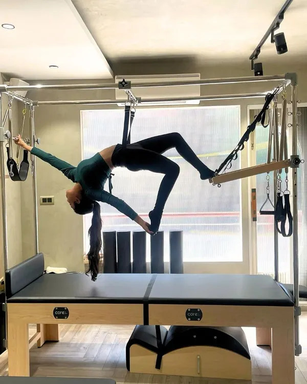 Pilates is a work of art on the Cadillac. This advanced hanging exercise demonstrates incredible core strength, flexibility, and trust in the equipment.
