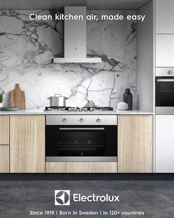 A seamless, modern kitchen featuring an integrated Electrolux oven and a powerful chimney hood. We design and install complete kitchen systems where technology and aesthetics work in harmony for a truly elevated cooking experience.