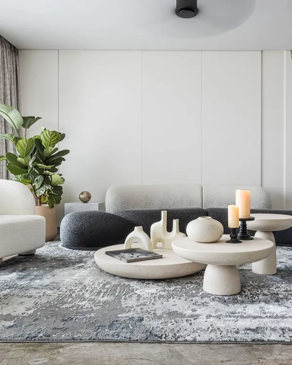 When designing a living room, our focus is on creating a space that’s functional, inviting, and a true reflection of your personal style. Here, we used distinct areas for different activities, using sculptural furniture and a textured rug to define the zones.