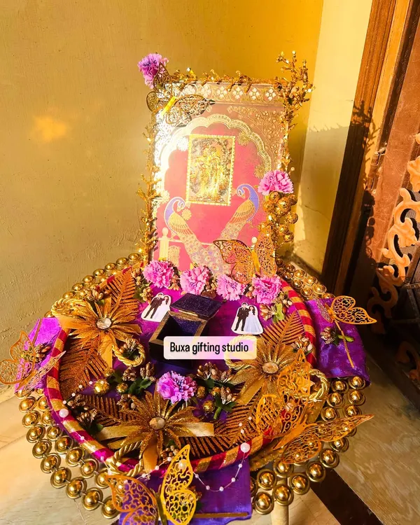 This custom engagement platter is one of my proudest creations. My client envisioned a story of divine love with Radha Krishna, peacocks, and butterflies, and I brought it to life with a 24-carat gold-plated idol, rich purple satin, and intricate gold details. It’s more than a gift; it’s a keepsake for a new beginning.