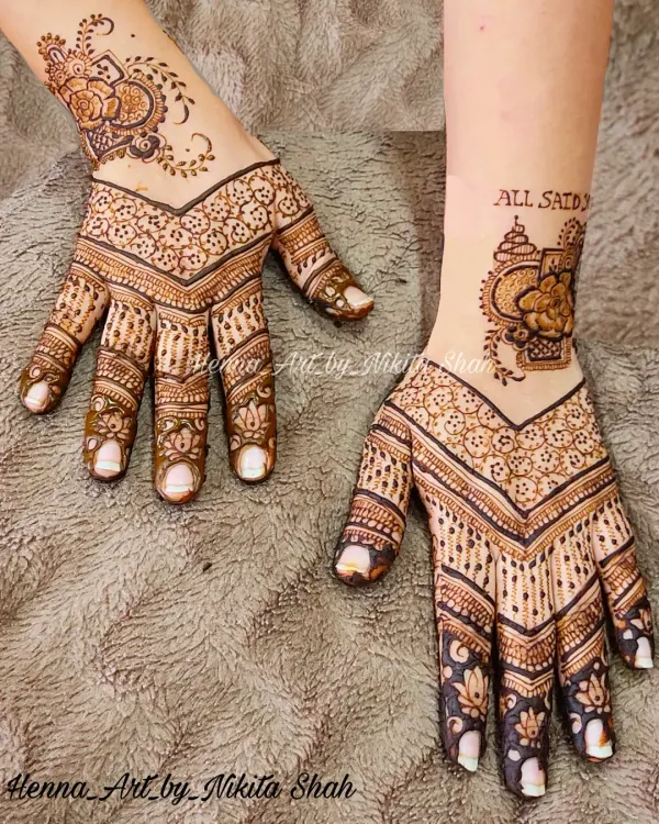 A beautiful and popular back-hand design. This style features a modern V-shape pattern that elongates the hand, combined with delicate floral work and a unique wrist cuff element.