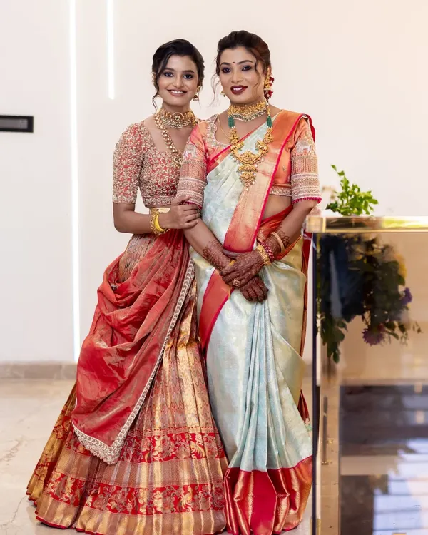 A heartwarming portrait of a mother and daughter for their house warming ceremony, both looking graceful and elegant.