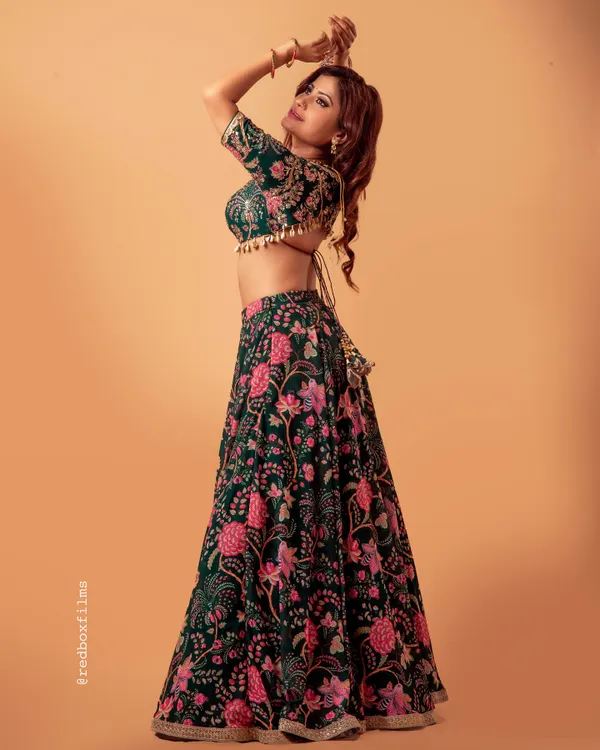 This custom green floral lehenga is perfect for a daytime wedding or a garden party. The blouse features a delicate back tie and tassels, and the full skirt has a beautiful flair for that perfect twirl.