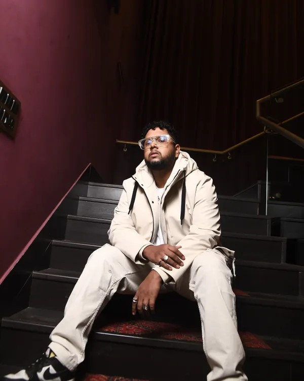 This is a shot from a recent photoshoot. The all-white fit on the stairs, it's a whole mood. This is the kind of confidence I bring to my music.