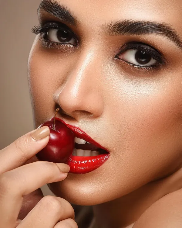 This is a perfect example of the high-impact beauty photography I specialize in. For this shot, we focused on creating a bold look with glossy red lips and flawless skin, using a cherry as a prop to add a touch of playful drama. The lighting is carefully controlled to highlight texture and create a polished, editorial feel.