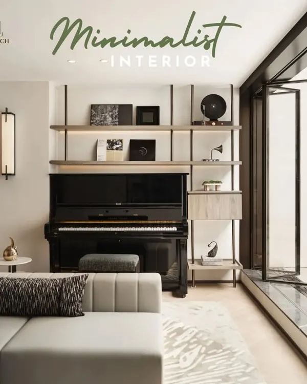 This minimalist living room design features a sleek piano set against a custom-built shelving unit. The space is designed to be calm and uncluttered, with natural light from the large glass doors creating a serene ambiance.