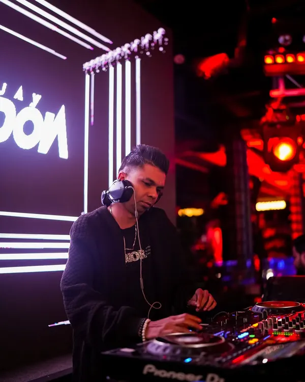 Deep in concentration, lining up the next track. A professional shot of me at the console with my name lit up on the screen behind me.