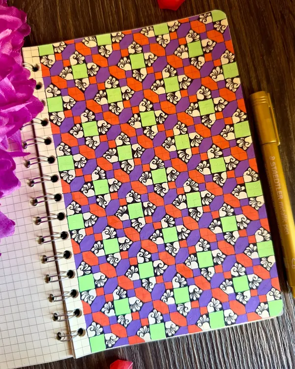 A page from my art journal, filled with a vibrant geometric pattern. The combination of purple, orange, and lime green creates a playful and energetic design. This is truly my kind of therapy.