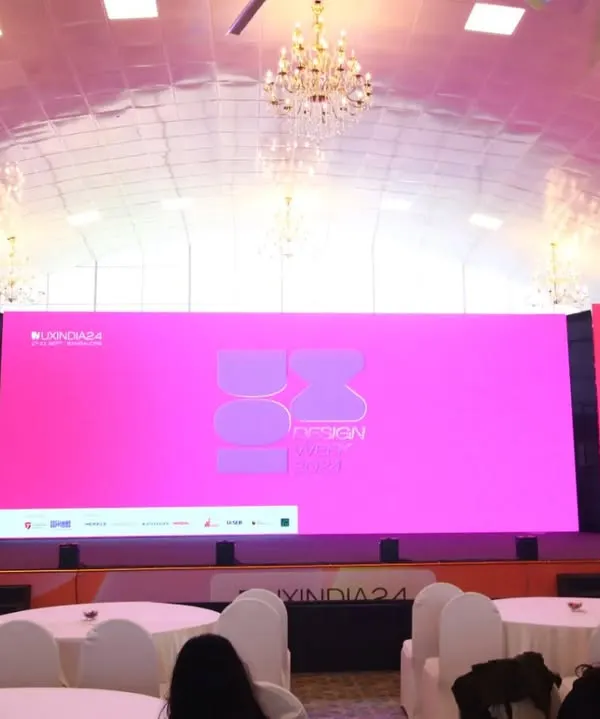 This image showcases the impressive stage and lighting setup for the UXINDIA 2024 summit before the audience arrives, highlighting our attention to capturing the professional ambiance of the venue.