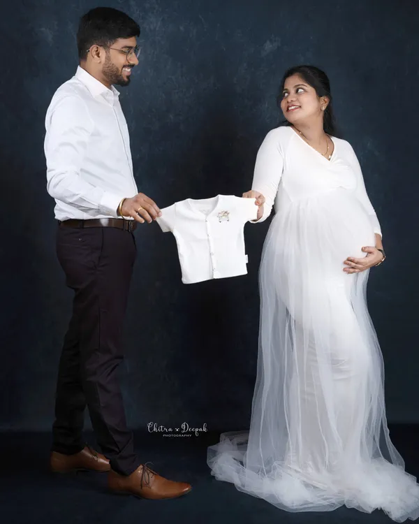 A tiny outfit for a tiny human on the way. Using baby clothes as props is a sweet and classic way to announce your excitement.
