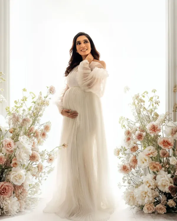 A dreamy, angelic portrait. Framed by delicate flowers and bathed in soft light, this mama to be looks absolutely radiant in a flowing white gown from my studio wardrobe.