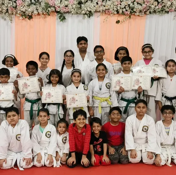 A proud moment for the entire group at our belt and certificate distribution ceremony at Rejoice International School. It's wonderful to see students of all levels, from orange to purple belts, celebrating their progress together.