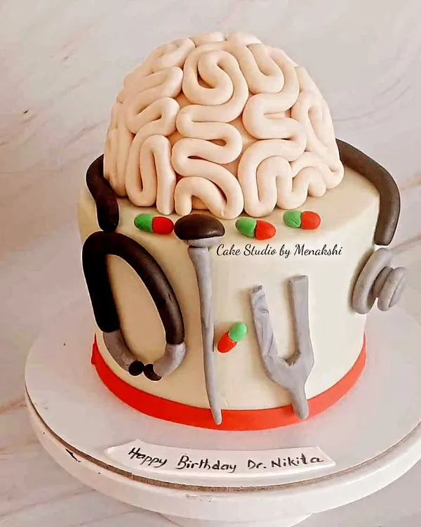 A cake for a neurosurgeon. This unique design features an edible brain, a stethoscope, and other tools of the trade, all handcrafted with care.