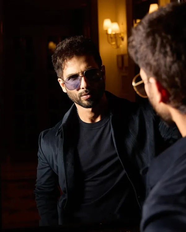 Shahid Kapoor looking sharp as ever for his 'DEVA' promotions. This custom all-black look from Raamz Label, seen here in a moody reflection, is the definition of sleek.