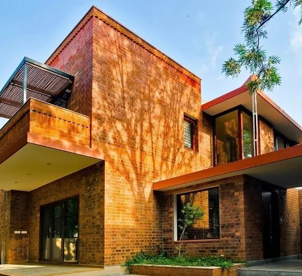 This is the Vidyut Kapoor Residence in Bangalore, a prime example of our modern architectural style using exposed brick. The design emphasizes clean geometric lines and the interplay of solid and void, creating a dynamic facade that interacts with natural light throughout the day.