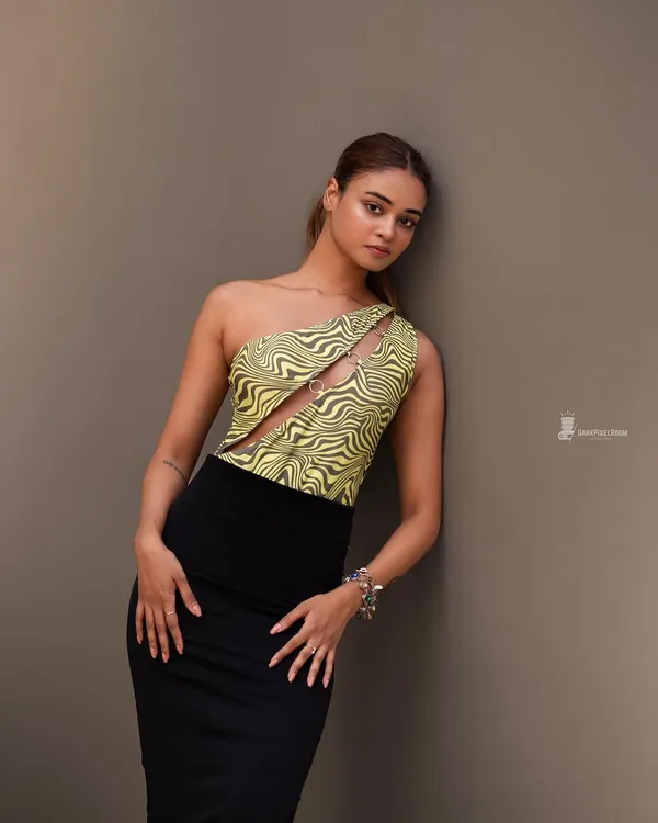 A clean, minimalist studio portrait. The focus is on the subject's pose and the interesting lines of her outfit, showing my versatility in a studio environment.