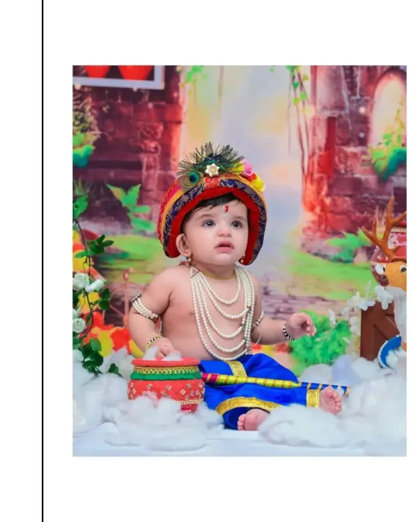 A serene portrait of a baby boy dressed as Little Krishna, looking up with a gentle expression. The detailed costume, including pearl necklaces and a peacock feather crown, is perfect for a Janmashtami theme.
