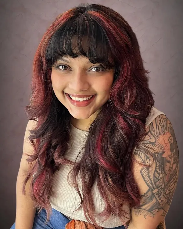 This is Amrapali's rock-chick shag haircut, taken to the next level with fiery red accents. The color placement highlights the edgy layers of the cut.