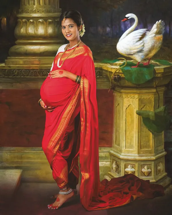 A unique maternity portrait inspired by the classic paintings of Ravi Varma. Dressed in a traditional red saree, this mom-to-be looks like a timeless work of art, complete with rich colors and elegant props.
