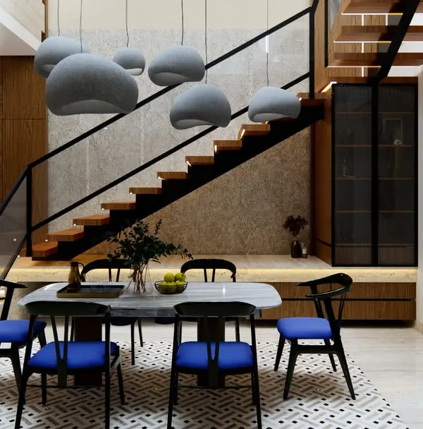 This dining space from our Project Yūgen is designed to be the heart of the home. We combined a sleek marble-top table and bold blue chairs with warm wooden stairs and statement pendant lights to create an area that is perfect for both family meals and elegant entertaining.